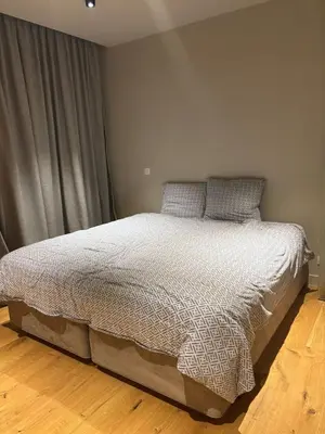 a bedroom with a bed with a white comforter at Spacious luxurious 1 bedroom stay in the city center in Antwerp