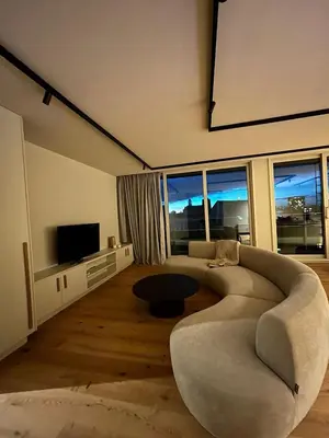 a living room with a couch and a tv at Spacious luxurious 1 bedroom stay in the city center in Antwerp
