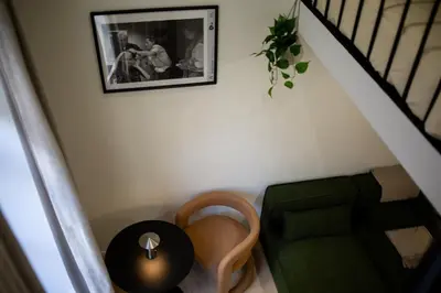a stair room with a table and a picture on the wall at Charmant studio avec mezzanine et terasse in Brussels