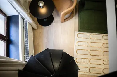 a black umbrella sitting in the corner of a room at Charmant studio avec mezzanine et terasse in Brussels