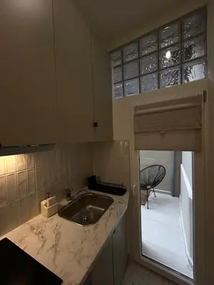 a kitchen with a sink and a counter top at Charmant studio avec mezzanine et terasse in Brussels