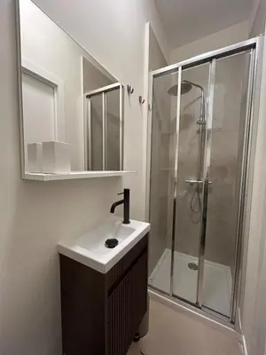 a bathroom with a sink and a shower at Charmant studio avec mezzanine et terasse in Brussels