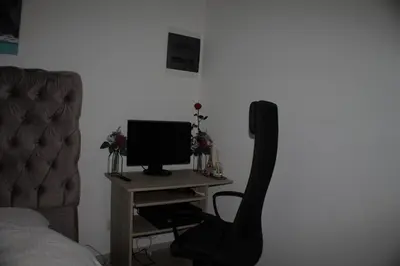 a bedroom with a desk with a computer and a chair at Luxurious Apartment in Brussels