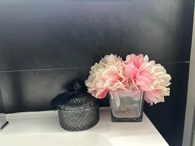 two pink flowers in a vase on a table at Luxurious Apartment in Brussels