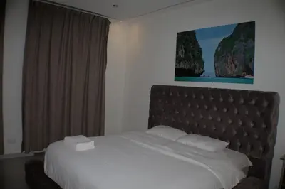 a bed in a hotel room with a large window at Luxurious Apartment in Brussels