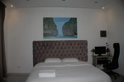 a bedroom with a bed and a desk with a computer at Luxurious Apartment in Brussels