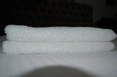 a stack of towels sitting on top of a table at Luxurious Apartment in Brussels