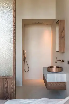 a bathroom with a copper sink and a bed at Montevideo Penthouse in Antwerp