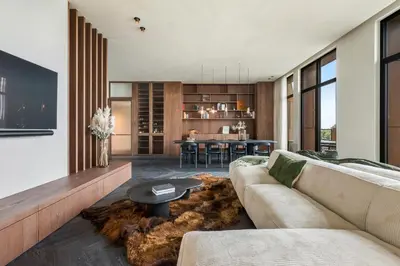 a living room with a couch and a table at Montevideo Penthouse in Antwerp