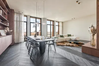 a living room with a table and a couch at Montevideo Penthouse in Antwerp