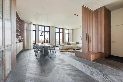a living room with a table and a couch at Montevideo Penthouse in Antwerp