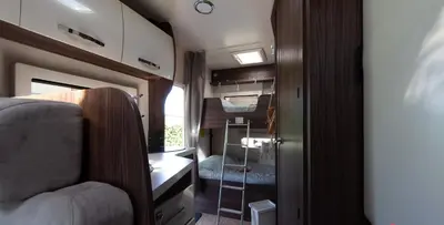 a small room with a bed and a glass door at Camper max 5p, unique experience, terras, central Belgium in Denderleeuw