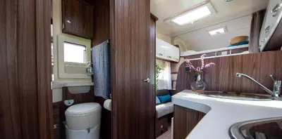 a small bathroom with a sink and a toilet at Camper max 5p, unique experience, terras, central Belgium in Denderleeuw