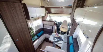 an inside view of an rv with a table in it at Camper max 5p, unique experience, terras, central Belgium in Denderleeuw