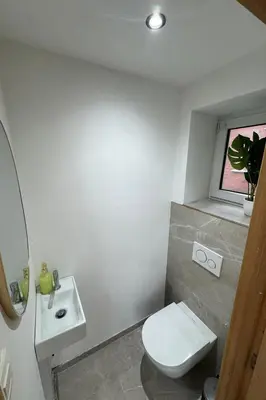a bathroom with a white toilet and a sink at Villa aux portes de Bruxelles in Dilbeek