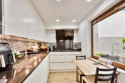 a kitchen with white cabinets and a wooden table at Vanderdussen in Brussels