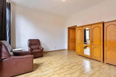 a living room with a couch and a chair at Vanderdussen in Brussels