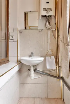 a white bathroom with a sink and a window at Vanderdussen in Brussels