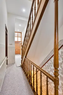 a staircase with wooden railings in a house at Vanderdussen in Brussels