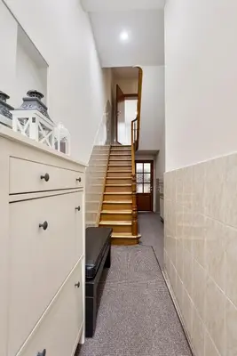 a kitchen with a staircase with a bench in a room at Vanderdussen in Brussels