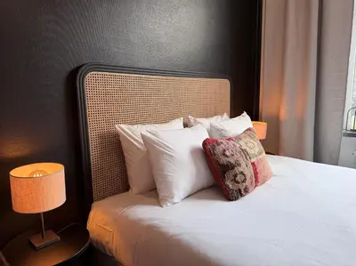 a bedroom with a bed with white pillows at Modern 2-Bedroom Apartment for 4 Guests, In a Prime Location Close to the Train Station and the Historic Center of Ghent in Ghent