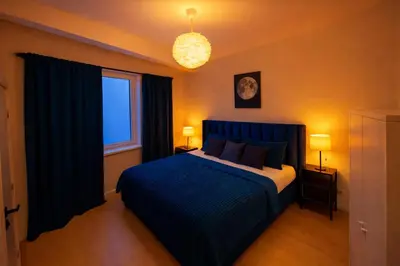 a bedroom with a bed with blue sheets and a window at Brussels City Fresh Oasis in Brussels