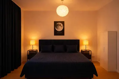 a bedroom with a bed with two night stands and two lamps at Brussels City Fresh Oasis in Brussels