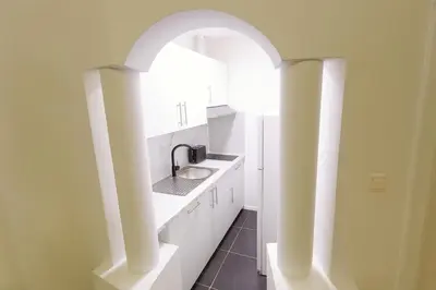 a kitchen with a sink and an archway at Brussels City Fresh Oasis in Brussels