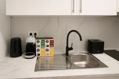 a kitchen counter with a sink and a sink at Brussels City Fresh Oasis in Brussels
