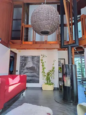 a living room with a red couch and a chandelier at Villa West heaven Valley Gent in Ghent