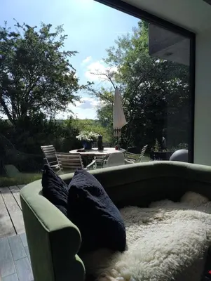 a couch with pillows sitting in front of a window at Villa West heaven Valley Gent in Ghent