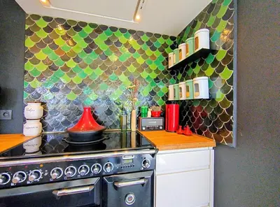 a kitchen with a stove and a colorful wall at Villa West heaven Valley Gent in Ghent