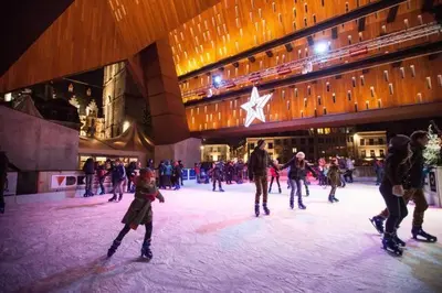 a group of people skating on an ice rink in a building at Villa West heaven Valley Gent in Ghent