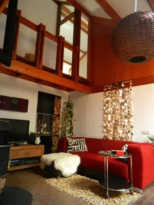 a living room with a red couch and a table at Villa West heaven Valley Gent in Ghent