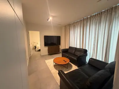 a living room with a couch and a table at Business Accommodation Mol Centre in Mol