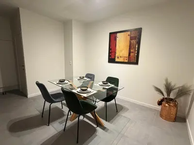 a dining room with a glass table and chairs at Business Accommodation Mol Centre in Mol