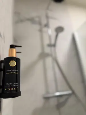 a black bottle of soap sitting on a bathroom counter at Business Accommodation Mol Centre in Mol