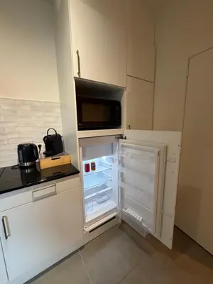 a kitchen with an open refrigerator with a microwave at Business Accommodation Mol Centre in Mol