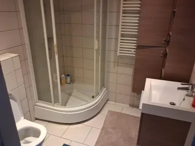a bathroom with a shower and a toilet and a sink at apart studio no3 in Kortenberg