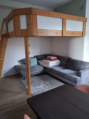 a living room with a couch and a loft bed at Apart studio3 in Kortenberg