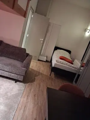 a living room with a bed and a couch at Apart studio3 in Kortenberg