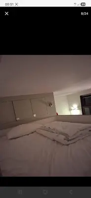 a white bed in a room with avertisement at Apart studio3 in Kortenberg