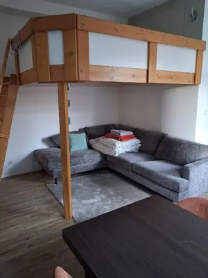 a living room with a couch and a loft bed at Apart studio3 in Kortenberg