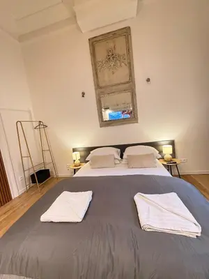 a bedroom with a large bed with two towels on it at European Lodge Studio Brussels in Brussels