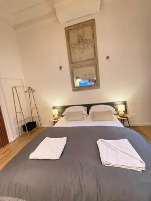 a bedroom with a large bed with two towels on it at European Lodge Studio Brussels in Brussels