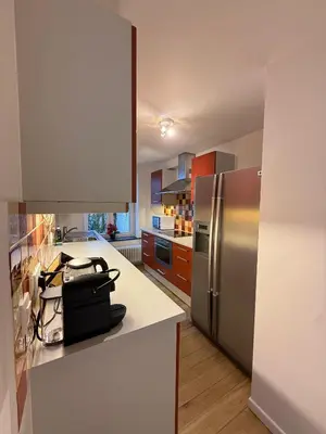 a kitchen with a stainless steel refrigerator and cabinets at European Lodge Studio Brussels in Brussels