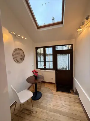 a room with a table and a chair and a window at European Lodge Studio Brussels in Brussels