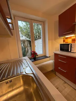 a kitchen with a sink and a microwave at European Lodge Studio Brussels in Brussels