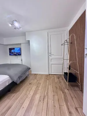 a bedroom with a bed and a wooden floor at European Lodge Rooms Brussels in Brussels