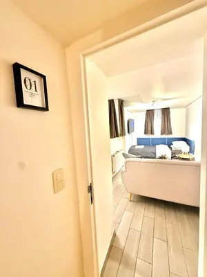 a view of a bedroom with a bed and a mirror at European Lodge Rooms Brussels in Brussels